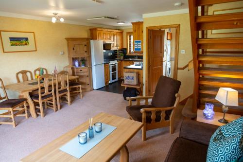 a kitchen and living room with a table and chairs at Scandinavian Village Ltd in Aviemore