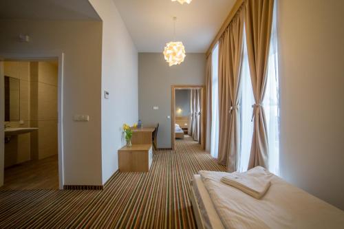a hotel room with a bed and a bathroom at Hotel Bachledówka in Zakopane