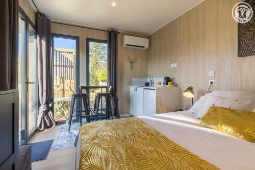 a bedroom with a large bed and a balcony at La cabane du pecheur in Aix-les-Bains