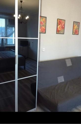 a bedroom with a bed and a glass wall at VIP apart 401 in Tbilisi City