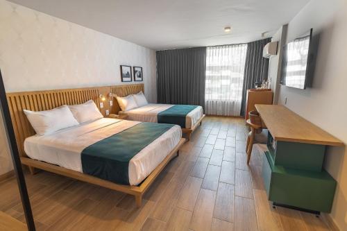 Postel nebo postele na pokoji v ubytování Oliva Plaza Hotel