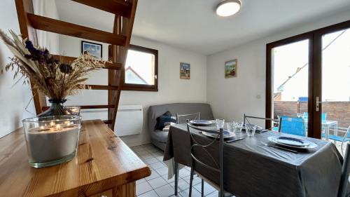 une salle à manger avec une table avec des chaises et un buffet dans l'établissement L'Estran 43, au Crotoy