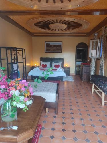 uma sala de estar com uma cama e uma mesa em Petit paradis em Sidi Bibi