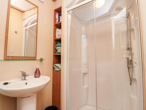 a bathroom with a shower and a sink at 12 Broughton Park - Sanctuary in Morecambe