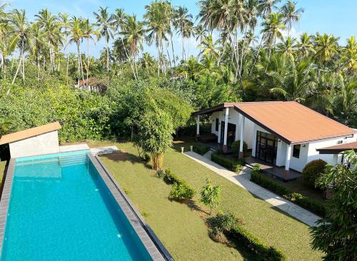 an aerial view of a house with a swimming pool at Sanda Eliya Resort in Bentota