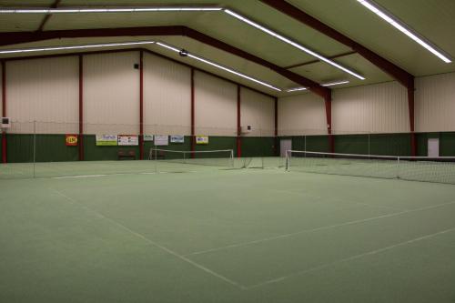 a tennis court with several tennis rackets on it at Hotel Rottal in Otrokovice