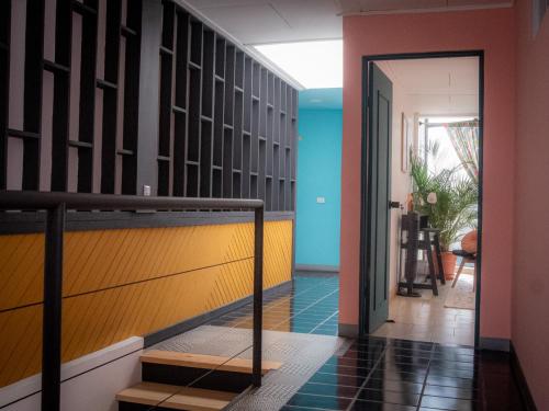 a hallway with a staircase leading to a room at Lolas Hostal, Habitacion Exclusiva para Mujeres, 2 camarotes, precio por cama in San José