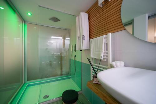 a bathroom with a tub and a sink and a shower at Grenilù Sea in Crotone