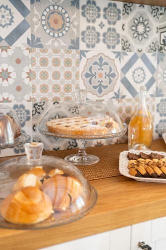 a table with bread and pastries on a table at Grenilù Sea in Crotone