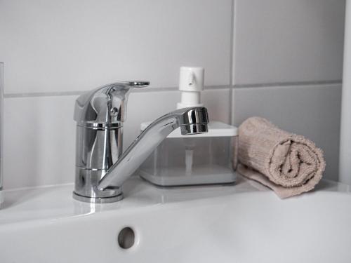 a bathroom sink with a faucet and a towel at Apartmány u Maxíků in Horní Maršov
