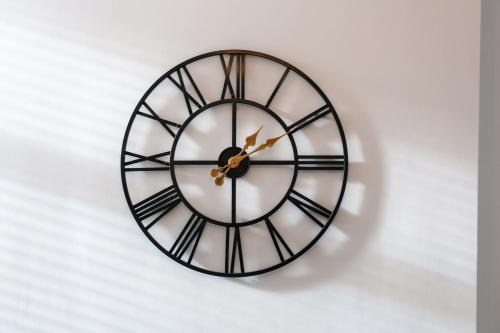 a black and white clock on a white wall at Asher Suite by Koya Homes - 2-Bedroom Home, Downtown Barry, Free Parking in Barry