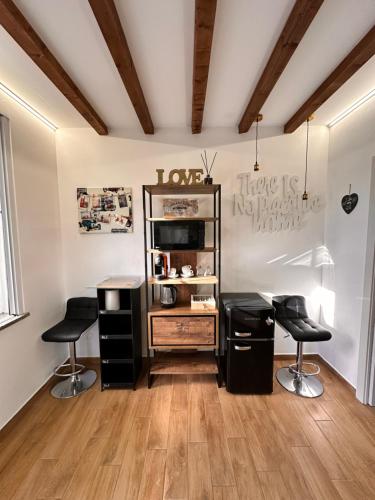 a room with a desk and two stools at CA FOSCARI Apartments San Siro in Milan