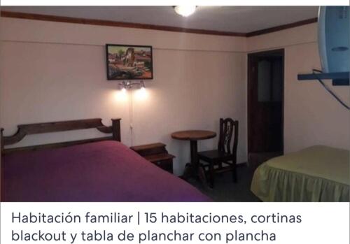 a bedroom with a bed and a table and a chair at Hotel Oasisa in Uyuni