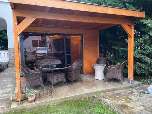 a gazebo with chairs and a table on a deck at Villa Campana in Siófok