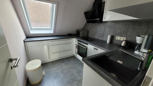 a small kitchen with a sink and a window at Casa Bella in Weeze