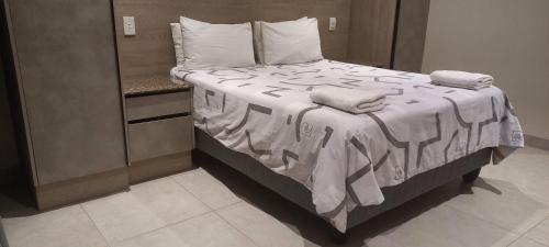 a bed with two towels on it in a room at The House Of The Rising Sun in Scottburgh