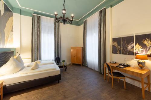 Ένα ή περισσότερα κρεβάτια σε δωμάτιο στο Villa Thea Hotel am Rosengarten