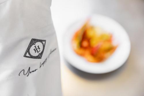 a white plate of food on a table at De Lindenhoeve Boutique Hotel in Sluis