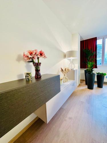 a living room with a table with flowers on it at Urbanstay Suites Grand Place Luxury Apartment in Brussels