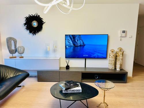 a living room with a flat screen tv on a wall at Urbanstay Suites Grand Place Luxury Apartment in Brussels