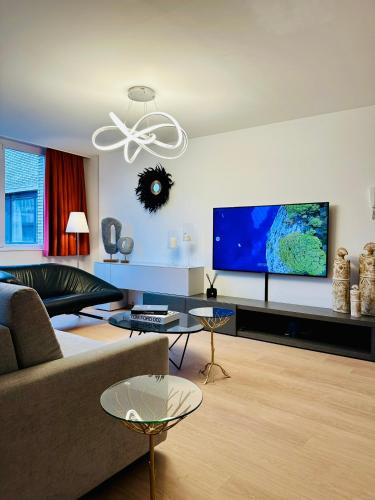 a living room with a couch and a flat screen tv at Urbanstay Suites Grand Place Luxury Apartment in Brussels