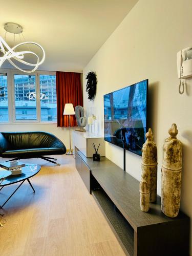 a living room with a couch and a flat screen tv at Urbanstay Suites Grand Place Luxury Apartment in Brussels
