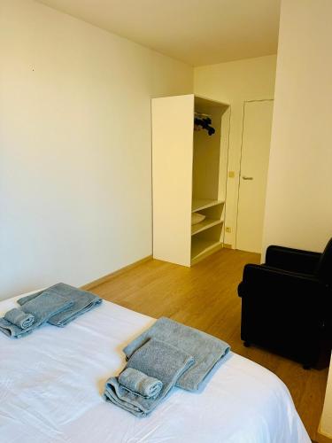 a bedroom with a bed with towels on it at Urbanstay Suites Grand Place Luxury Apartment in Brussels