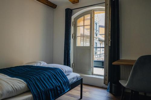 a bedroom with a bed and an open window at Capsule Hotel Nyhavn63 in Copenhagen