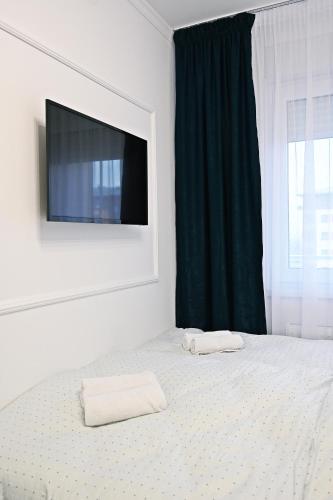 a bedroom with a bed with two towels on it at Hedonist Centar 7 Luxury Apartments in Doboj
