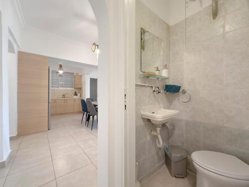 a bathroom with a toilet and a sink at Marnis Spacious 105 sqm apt in Athens in Athens