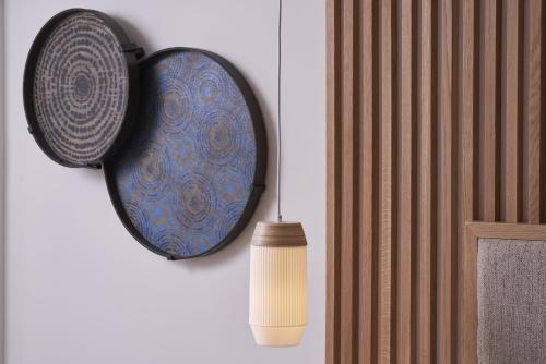 a plate and a candle hanging on a wall at Atlantica Bay - Adults Only in Limassol
