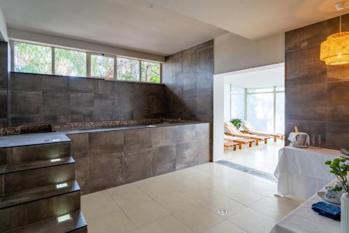 a kitchen with stainless steel appliances and a table at Le Dune Sicily Hotel in Catania