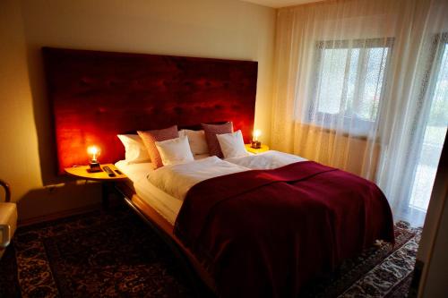 a bedroom with a large bed with a red headboard at Ferienwohnung Burg Freienstein Blick 4 Sauna in Gammelsbach