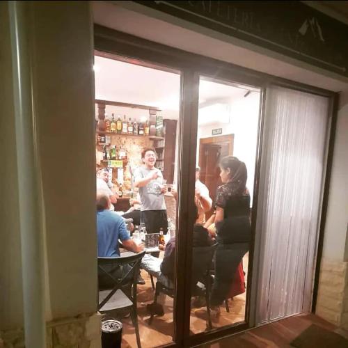 a group of people sitting at a table in a room at Alojamientos Rurales Entre Rocas in Ayna
