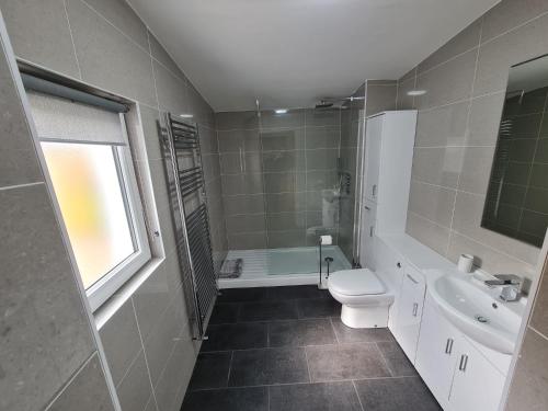 une salle de bain avec toilettes, lavabo et baignoire dans l'établissement Bruxie Holiday Cottages - River Cottage, à Maud