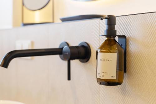 a bottle of soap is hanging on a wall at Kolibri Apartment in Elsbethen
