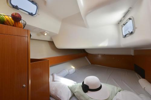 a person sitting on a bed in the back of a boat at Sun odyssey 43ib in Corfu Town