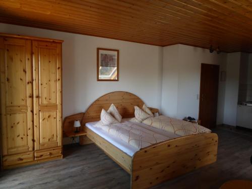 a bedroom with a wooden bed in a room at Gästehaus Balzer in Marburg an der Lahn