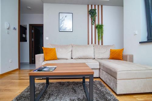 a living room with a couch and a coffee table at Titova Vila Zlatibor in Zlatibor