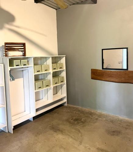 a room with a white cabinet and a window at Pachamama Tropical Garden Lodge in Carmen