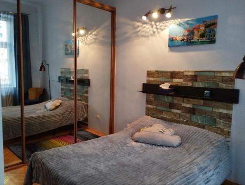 a bedroom with two beds and a mirror at Family Stay in Lviv (2 Rooms + Kitchen) in Kulʼparkuv