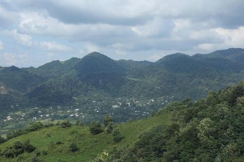a view of a mountain with a town in the distance at bukistsikhe in Chʼokhatauri