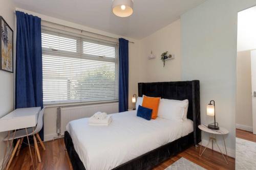 a bedroom with a large bed and a window at Charming North London Apartment in London