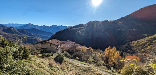an old house on a hill in the mountains at B&B Piccolo Tibet in Lavenone