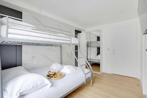 - une chambre avec 2 lits superposés et une table dans l'établissement Résidence Boulanger - République, à Paris