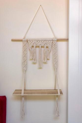 a wooden shelf with curtains on a wall at Tinyhouses - Domain "La vallée des Prés" in Bande