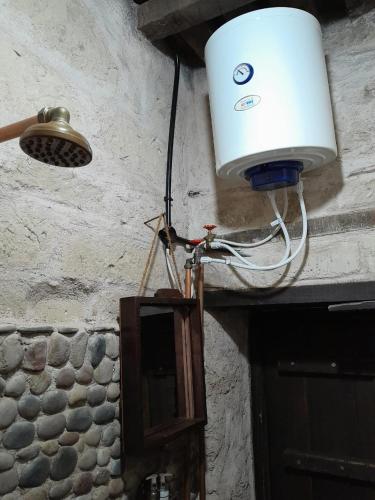 a light hanging from a wall with a light on it at نزل كوفان التراثي Koofan Heritage Lodge in Salalah