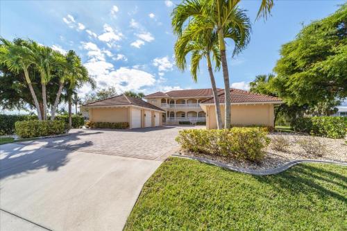 a house with palm trees and a driveway at 3329 Purple Martin 112 in Punta Gorda