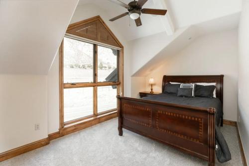 a bedroom with a bed and a window at Incredible 4BD Mtn Penthouse with Pool and Hot Tub, AC in Avon