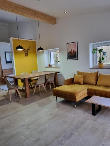 a living room with a couch and a table at Eiselehof Ferienwohnungen in Alleinlage in Rot am See